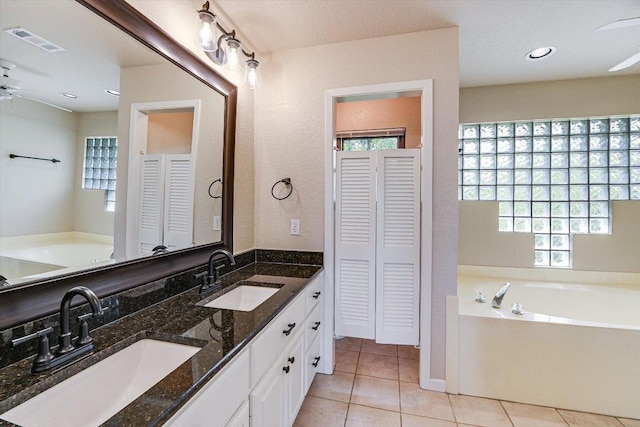 bathroom featuring visible vents, a ceiling fan, a closet, and a sink