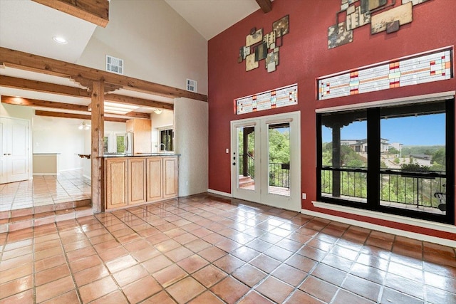 5000 High Canyon Pass, Austin, TX 78738 - unfurnished living room featuring beam ceiling, light tile patterned floors, high vaulted ceiling, and ceiling fan