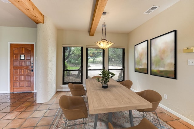 dining space with light tile patterned floors, visible vents, beamed ceiling, and baseboards
