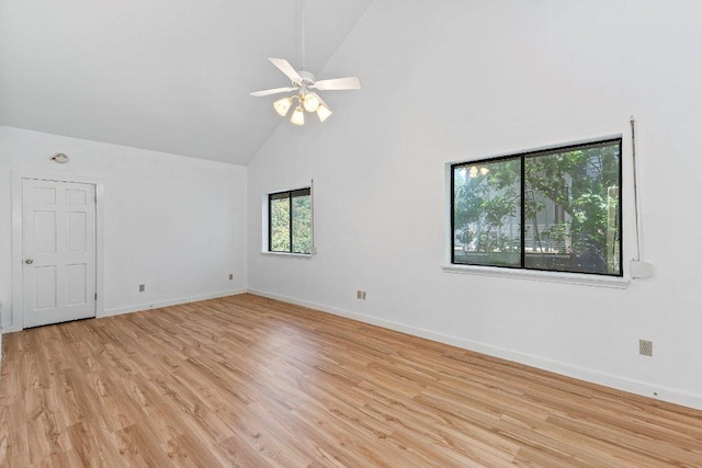 1313 Spyglass Dr, Austin, TX 78746 - empty room featuring light wood finished floors, baseboards, high vaulted ceiling, and a ceiling fan