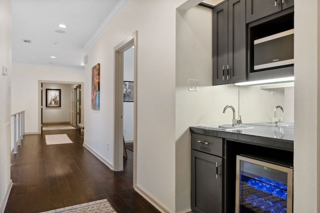 9 Swiftwater Trl, The Hills, TX 78738 - bar area with beverage cooler, ornamental molding, dark wood-type flooring, and recessed lighting