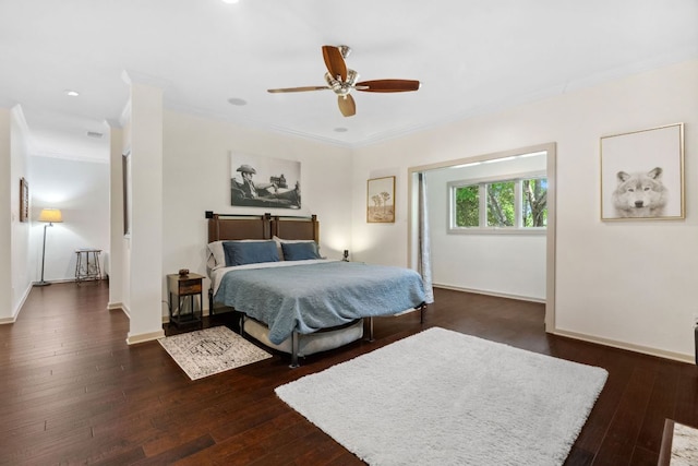bedroom featuring hardwood / wood-style floors, baseboards, ornamental molding, and a ceiling fan