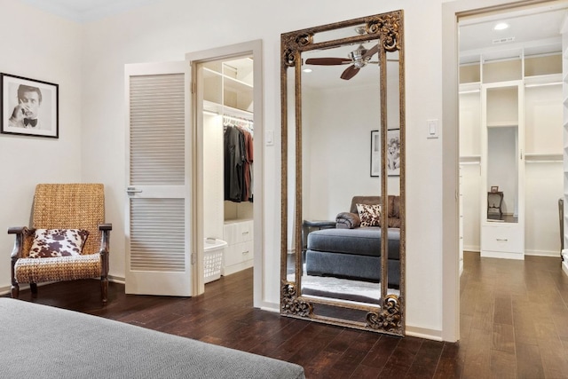 bedroom with dark wood finished floors, baseboards, and ornamental molding