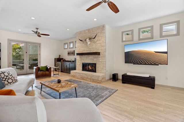 9 Swiftwater Trl, The Hills, TX 78738 - living room with a ceiling fan, wood finished floors, a stone fireplace, and recessed lighting