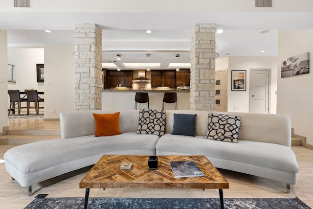9 Swiftwater Trl, The Hills, TX 78738 - living area featuring ornate columns, light wood-type flooring, and recessed lighting