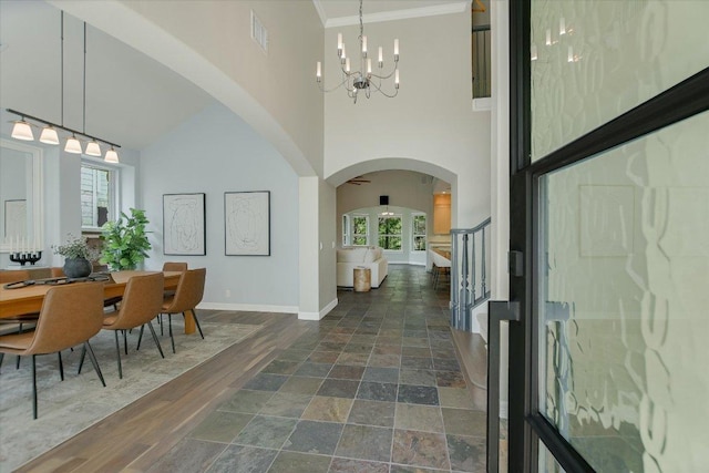 5412 Moon Shadow Dr, Austin, TX 78735 - entryway with baseboards, arched walkways, an inviting chandelier, and a high ceiling