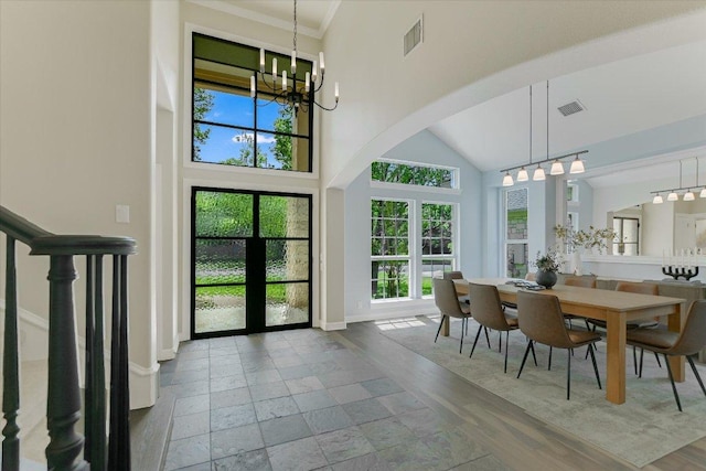 5412 Moon Shadow Dr, Austin, TX 78735 - dining room with arched walkways, an inviting chandelier, baseboards, and visible vents