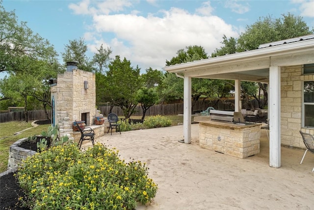 10 Scarlet Rdg, Austin, TX 78737 - fenced backyard with an outdoor stone fireplace, area for grilling, and a patio area