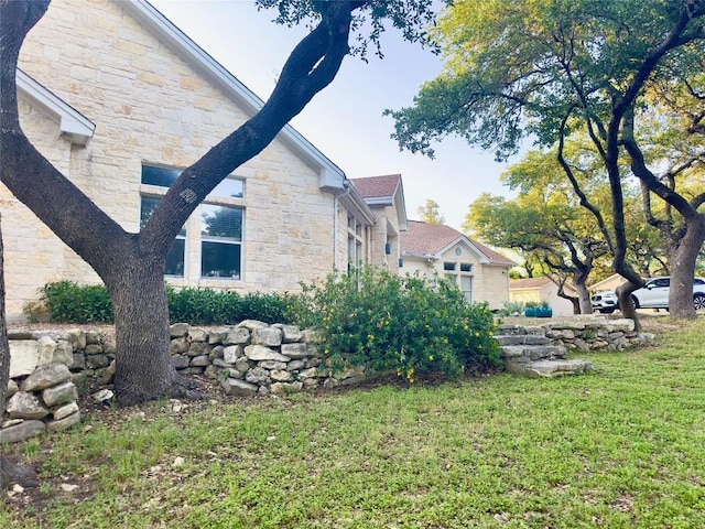 10 Scarlet Rdg, Austin, TX 78737 - view of home's exterior featuring stone siding and a lawn