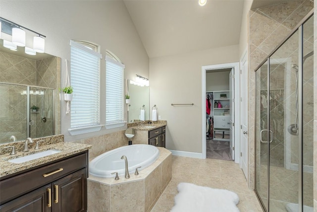 2421 Carretera Dr, Leander, TX 78641 - full bathroom featuring a shower stall, two vanities, a garden tub, lofted ceiling, and tile patterned flooring