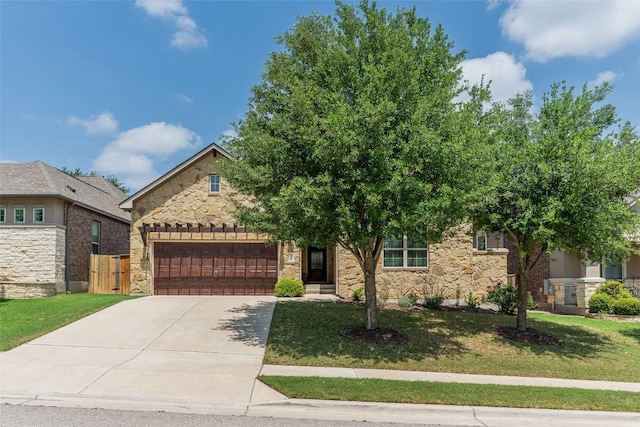 2421 Carretera Dr, Leander, TX 78641 - view of property hidden behind natural elements featuring stone siding, a garage, and concrete driveway