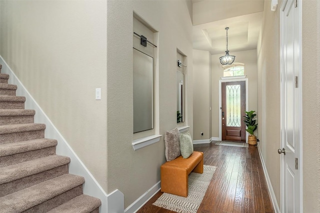 2421 Carretera Dr, Leander, TX 78641 - entryway with dark wood finished floors, a tray ceiling, stairway, and baseboards