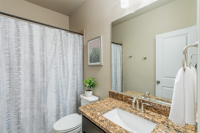 2421 Carretera Dr, Leander, TX 78641 - bathroom featuring vanity, a textured wall, and a shower with curtain