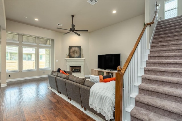 2421 Carretera Dr, Leander, TX 78641 - living room with healthy amount of natural light, ceiling fan, recessed lighting, a fireplace with raised hearth, and stairs