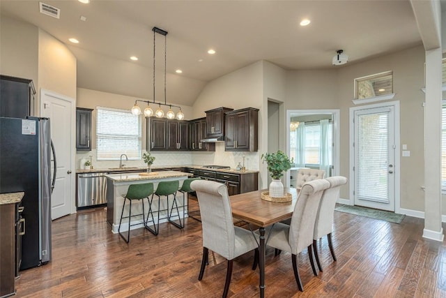 2421 Carretera Dr, Leander, TX 78641 - dining space with dark wood-type flooring, healthy amount of natural light, recessed lighting, vaulted ceiling, and baseboards