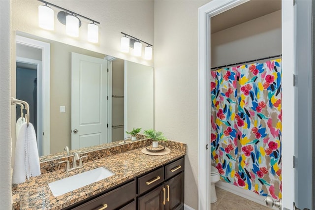 2421 Carretera Dr, Leander, TX 78641 - bathroom featuring vanity, toilet, tile patterned floors, and a shower with shower curtain