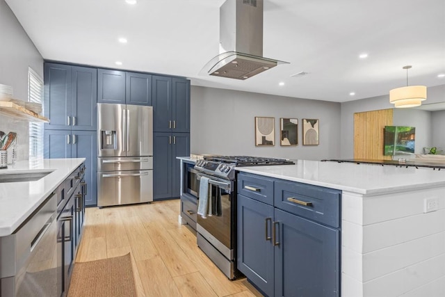 1712 Alleghany Dr, Austin, TX 78741 - kitchen with stainless steel appliances, island range hood, blue cabinets, light wood-style floors, and recessed lighting