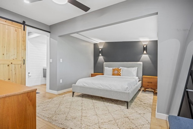 1712 Alleghany Dr, Austin, TX 78741 - bedroom featuring light wood-type flooring, baseboards, connected bathroom, and ceiling fan