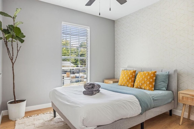 1712 Alleghany Dr, Austin, TX 78741 - bedroom featuring an accent wall, light wood-type flooring, baseboards, and ceiling fan