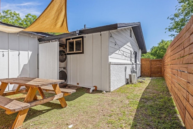 1712 Alleghany Dr, Austin, TX 78741 - view of side of home with stacked washer / dryer and board and batten siding