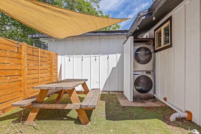 1712 Alleghany Dr, Austin, TX 78741 - view of patio featuring stacked washer / dryer, fence, a shed, and an outbuilding
