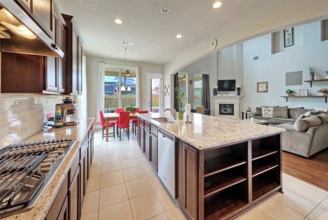 kitchen with recessed lighting, light stone countertops, under cabinet range hood, visible vents, and dishwasher