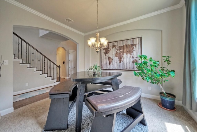 carpeted dining area featuring arched walkways, stairs, a chandelier, baseboards, and visible vents