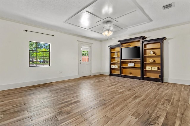unfurnished living room featuring a ceiling fan, attic access, wood finished floors, and visible vents