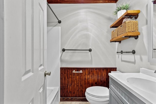 bathroom with vanity, tub / shower combination, and toilet