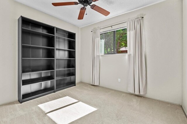 unfurnished room featuring carpet floors and ceiling fan