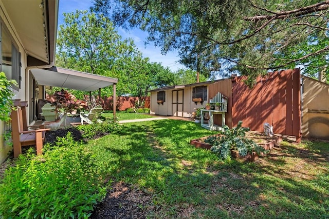 view of yard featuring an outdoor structure and fence private yard