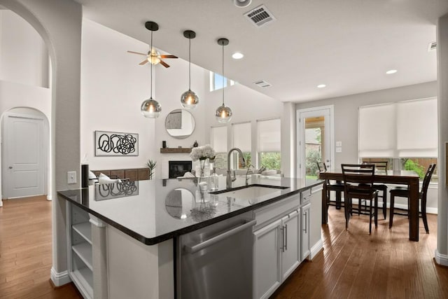 18617 Rio Chama Ln, Austin, TX 78738 - kitchen featuring dishwasher, arched walkways, a sink, ceiling fan, and recessed lighting