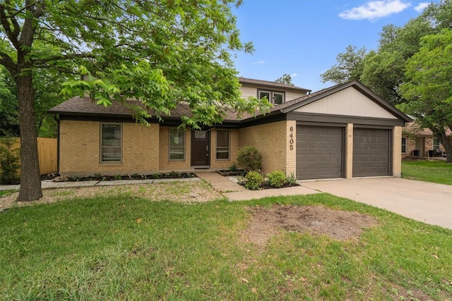 6405 Danwood Dr, Austin, TX 78759 - view of front of home with an attached garage, brick siding, and concrete driveway