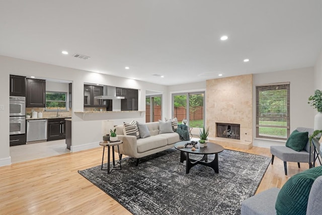 6405 Danwood Dr, Austin, TX 78759 - living area with healthy amount of natural light, light wood-style floors, a fireplace, and recessed lighting