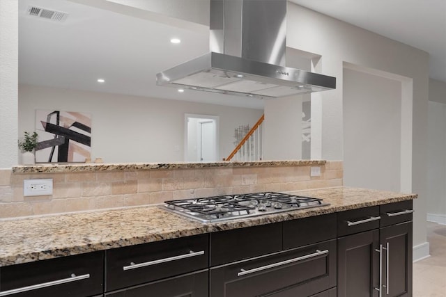 6405 Danwood Dr, Austin, TX 78759 - kitchen with wall chimney exhaust hood, stainless steel gas cooktop, tasteful backsplash, light stone counters, and recessed lighting