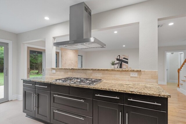 6405 Danwood Dr, Austin, TX 78759 - kitchen with extractor fan, stainless steel gas cooktop, tasteful backsplash, light stone countertops, and recessed lighting