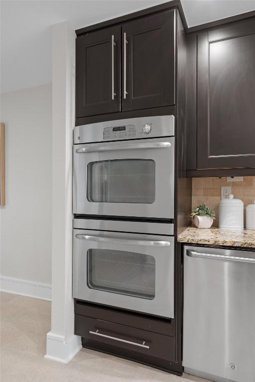 6405 Danwood Dr, Austin, TX 78759 - kitchen with stainless steel appliances, decorative backsplash, and light stone countertops