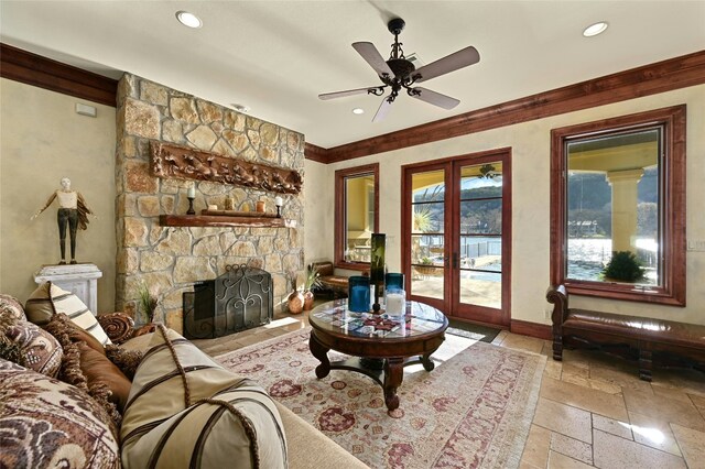 3111 Ski Shores Ter, Austin, TX 78730 - living area with stone tile flooring, recessed lighting, a stone fireplace, a ceiling fan, and crown molding
