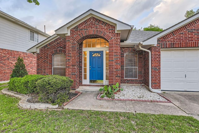 view of front of house featuring an attached garage and brick siding
