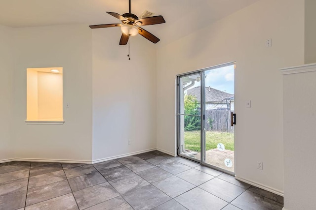 unfurnished room featuring baseboards, visible vents, a ceiling fan, and a high ceiling