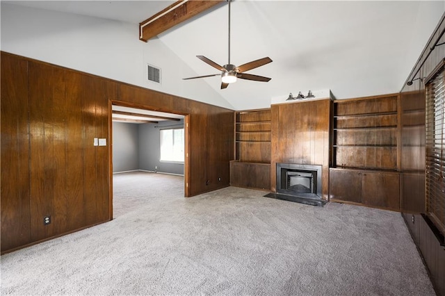 unfurnished living room with beamed ceiling, visible vents, carpet floors, a fireplace, and a ceiling fan