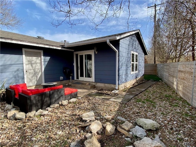 rear view of house featuring a fenced backyard