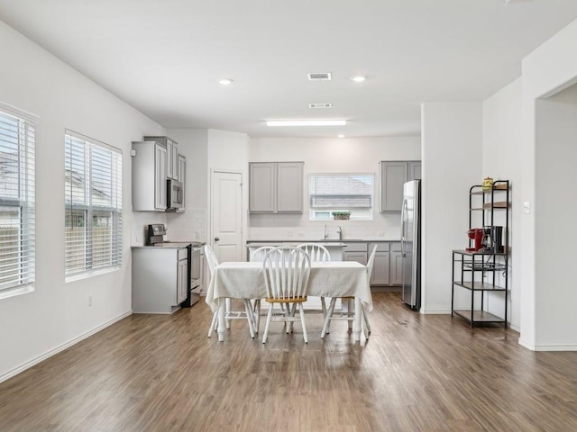 dining area with visible vents, recessed lighting, and wood finished floors