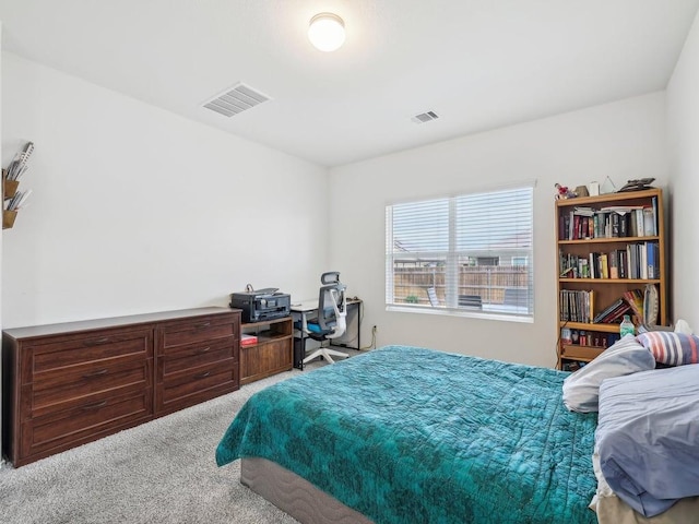 carpeted bedroom featuring visible vents