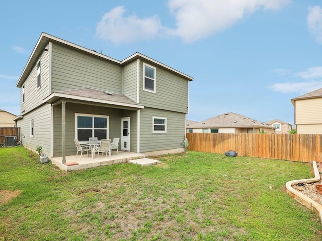 back of house with a yard, a fenced backyard, and central AC unit