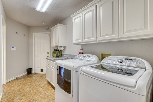 609 E Briarway Dr, Granite Shoals, TX 78654 - laundry room with a sink, cabinet space, washing machine and dryer, baseboards, and a textured ceiling