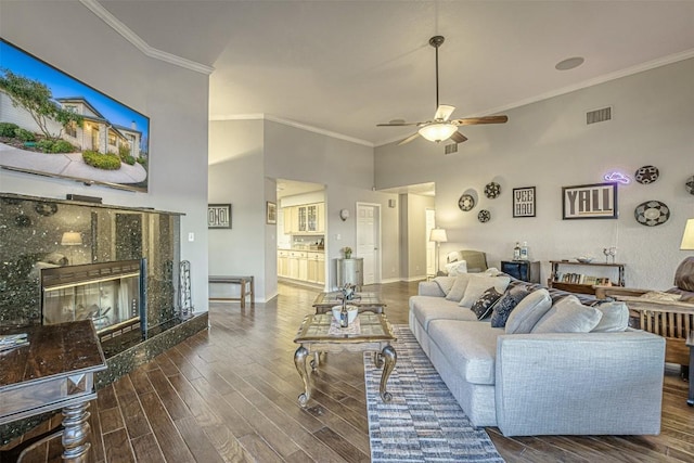 609 E Briarway Dr, Granite Shoals, TX 78654 - living area with a tile fireplace, ceiling fan, wood finished floors, ornamental molding, and a towering ceiling