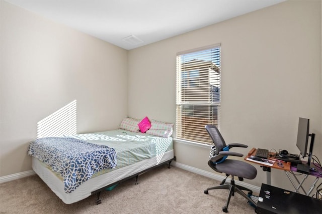 carpeted bedroom featuring baseboards