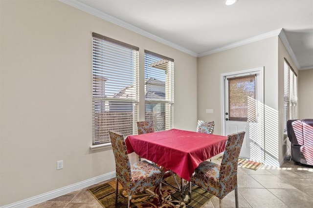 tiled dining room featuring baseboards and ornamental molding