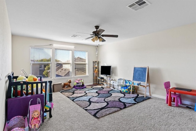 playroom featuring visible vents, ceiling fan, carpet floors, and baseboards